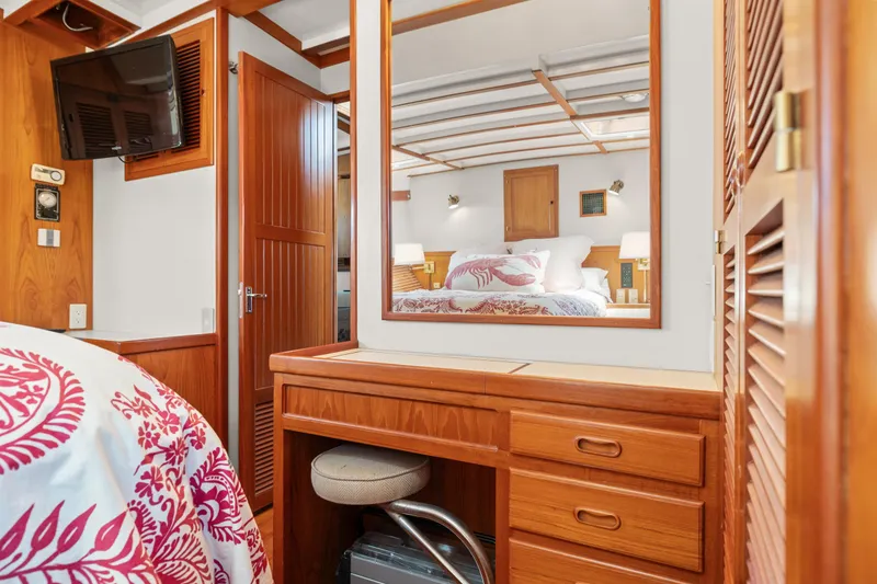 Slide: The Image of 1996 Kadey-Krogen 48 Whaleback cabin interior with wooden furniture and floral bedding. - 46