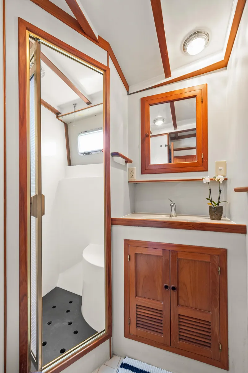 Slide: The Image of 1996 Kadey-Krogen 48 Whaleback bathroom with wood accents and shower. - 49