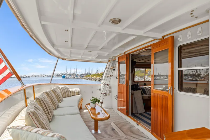 Slide: The Image of Luxurious 1996 Kadey-Krogen 48 Whaleback yacht with elegant interior and scenic marina view. - 5