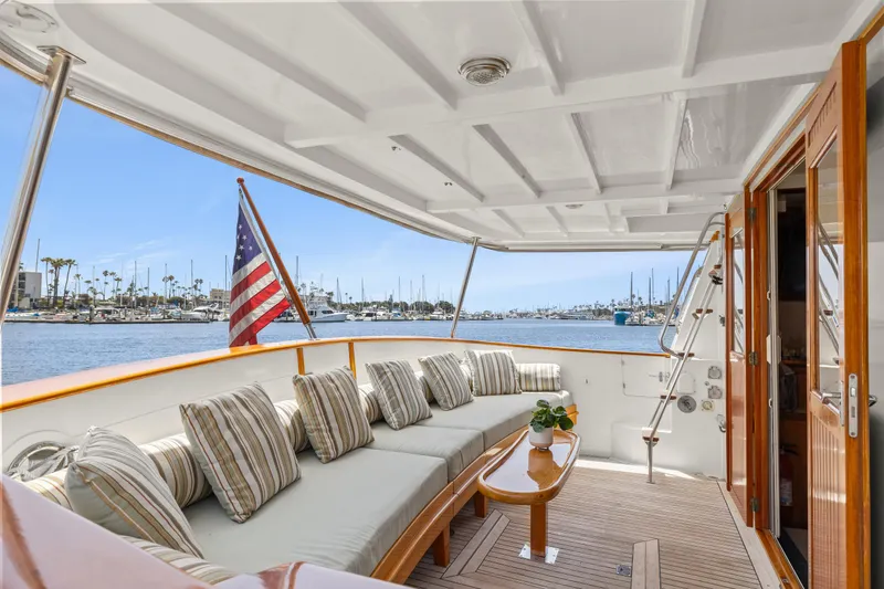 Slide: The Image of Luxurious 1996 Kadey-Krogen 48 Whaleback yacht deck with seating and American flag. - 6