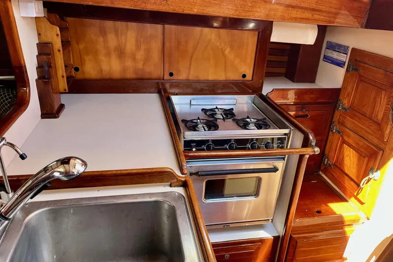 Slide: The Image of Galley kitchen in 1979 Cherubini 44 sailboat with stove and sink. - 12