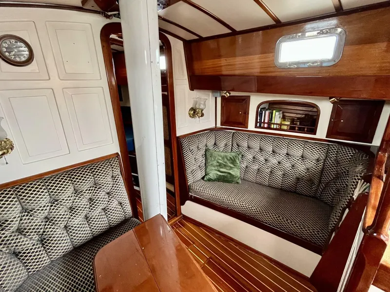 Slide: The Image of Interior of 1979 Cherubini 44 sailboat with wood paneling and cushioned seating. - 18