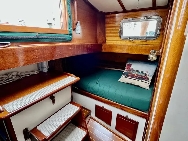 Slide: The Image of Cozy cabin interior of 1979 Cherubini 44 sailboat with wooden finish and nautical decor. - 21