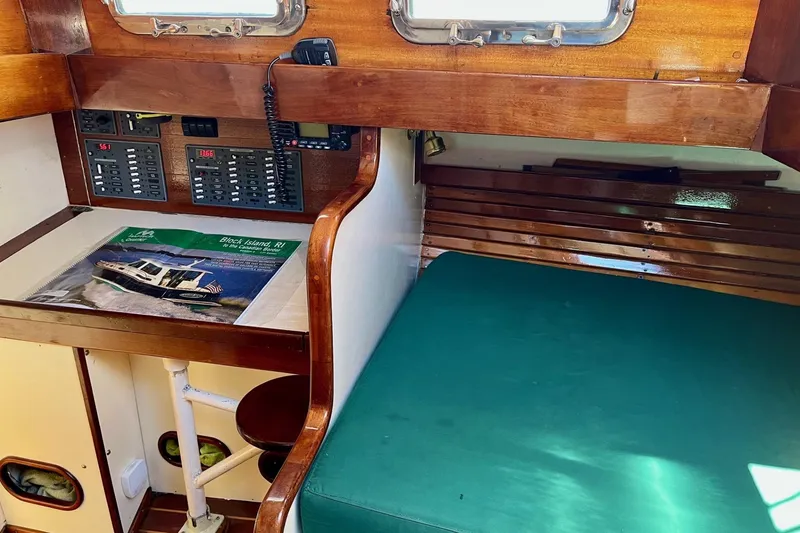 Slide: The Image of Interior of a 1979 Cherubini 44 sailboat with navigation station and seating area. - 22