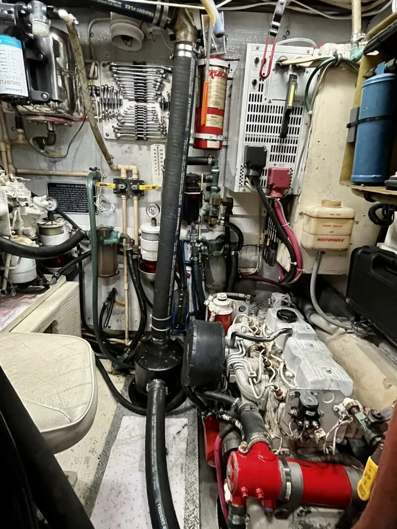 Slide: The Image of Engine room of a 1979 Cherubini 44 boat, featuring various mechanical components and wiring. - 29