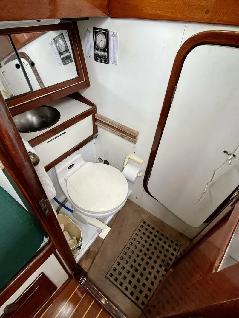 Slide: The Image of 1979 Cherubini 44 yacht bathroom with sink, toilet, and wooden accents. - 31