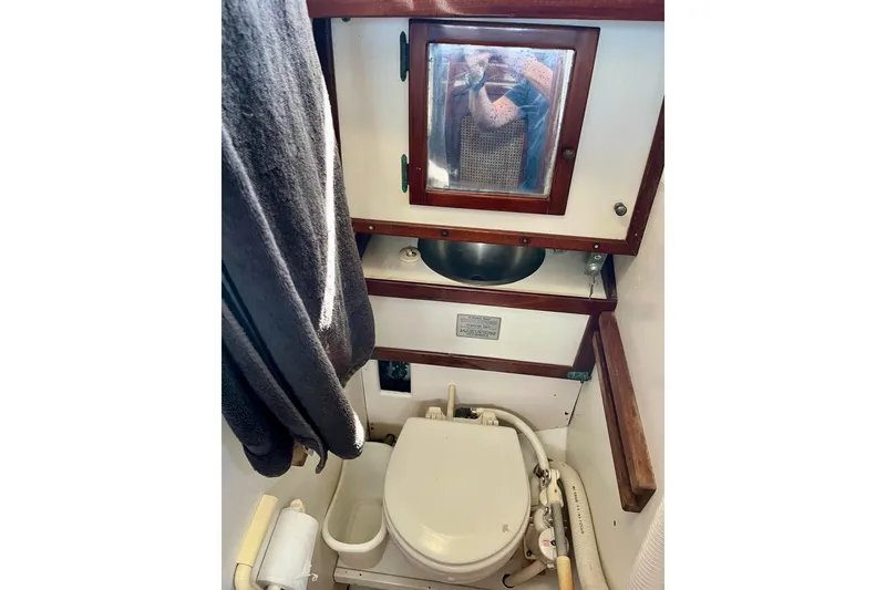 Slide: The Image of 1979 Cherubini 44 yacht bathroom with toilet, sink, and mirror. - 32