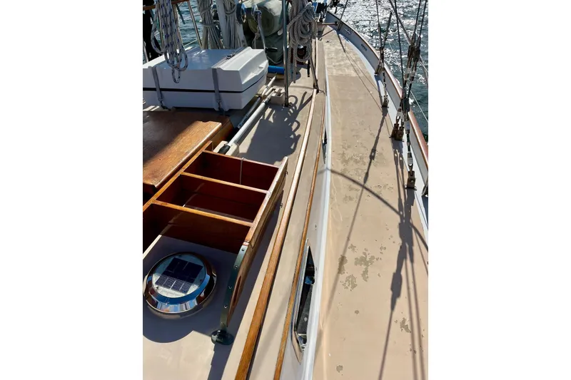 Slide: The Image of Deck view of 1979 Cherubini 44 sailboat with wooden details and rigging. - 5