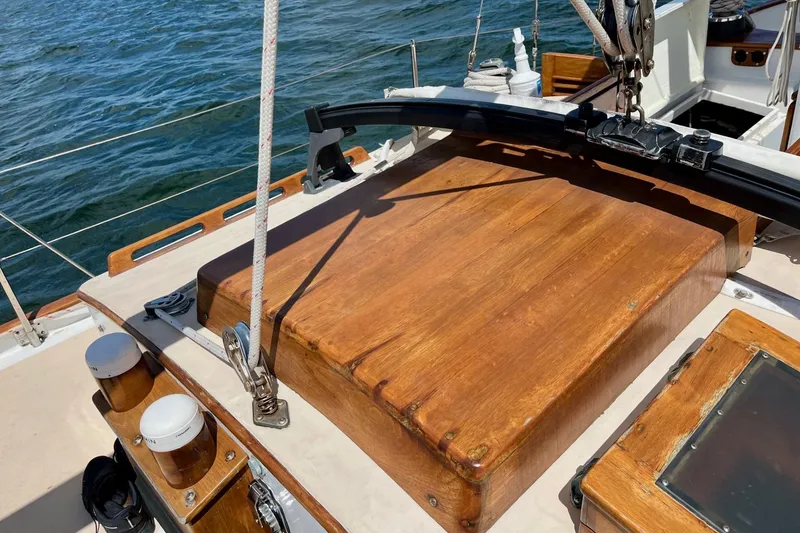 Slide: The Image of Wooden deck of 1979 Cherubini 44 sailboat with ocean backdrop. - 7