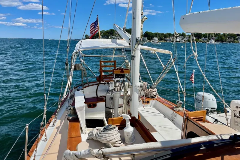 Slide: The Image of Cherubini 44 sailboat from 1979 on open water, featuring classic design and American flag. - 8