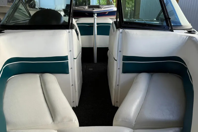 Slide: The Image of Interior of a 1996 MasterCraft 205 PRO STAR boat with white and teal seating. - 2