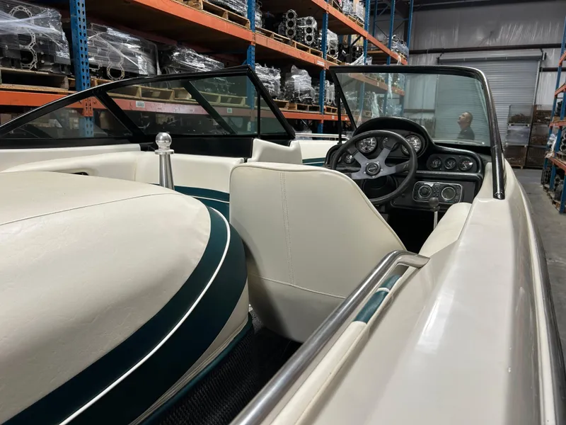 Slide: The Image of 1996 MasterCraft 205 PRO STAR boat interior with steering wheel and seating in warehouse. - 4