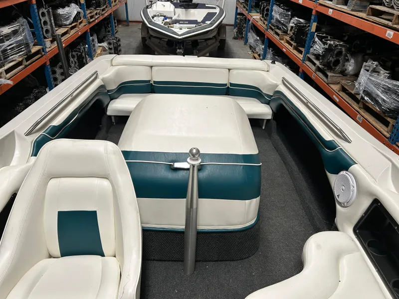 Slide: The Image of 1996 MasterCraft 205 PRO STAR boat interior with white and teal seating in storage. - 8