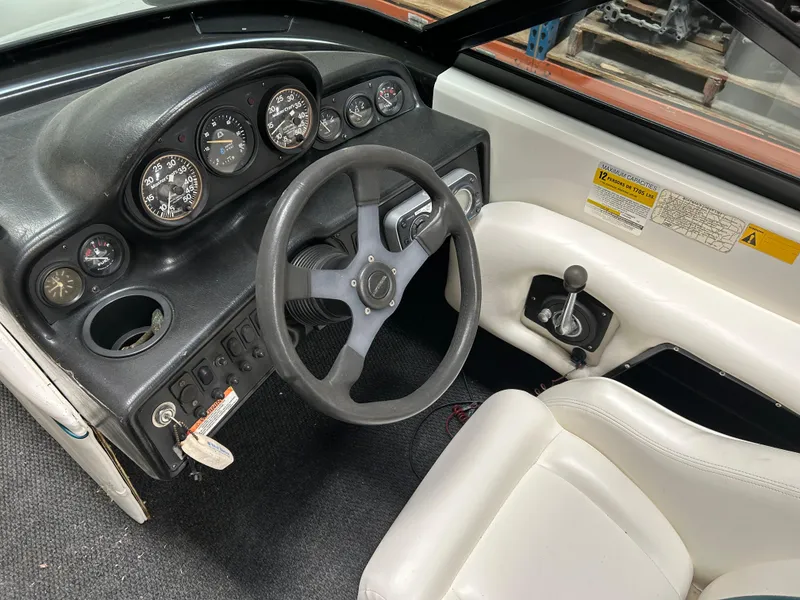 Slide: The Image of 1996 MasterCraft 205 PRO STAR boat dashboard with steering wheel and gauges. - 9
