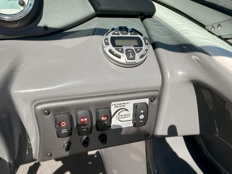Slide: The Image of 2016 Yamaha SX190 boat dashboard with control panel and stereo system. - 10