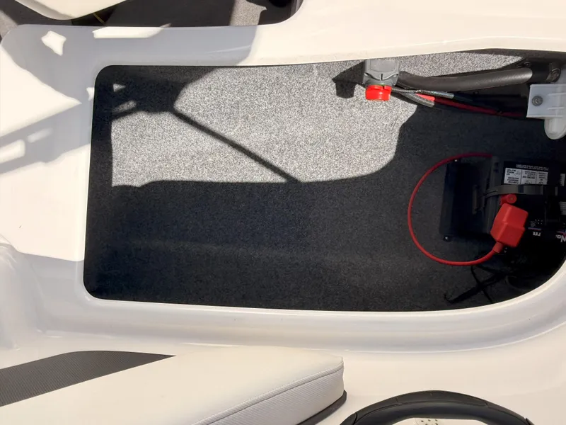 Slide: The Image of 2016 Yamaha SX190 boat interior storage compartment with battery and wiring. - 11