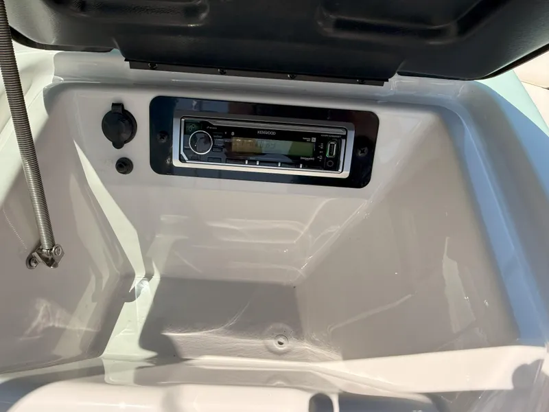 Slide: The Image of 2016 Yamaha SX190 boat stereo system in dashboard compartment. - 16