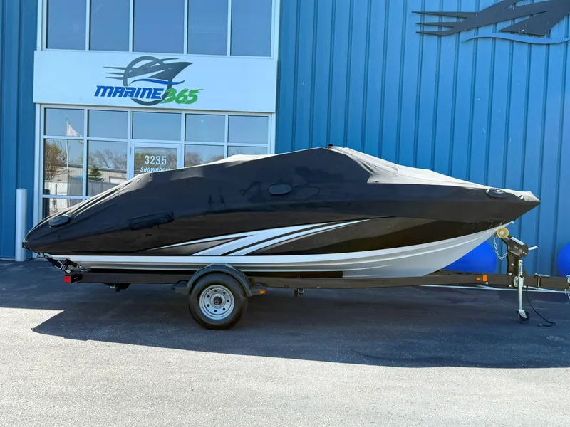 Slide: The Image of 2016 Yamaha SX190 boat with cover on trailer, parked outside Marine365 building. - 24