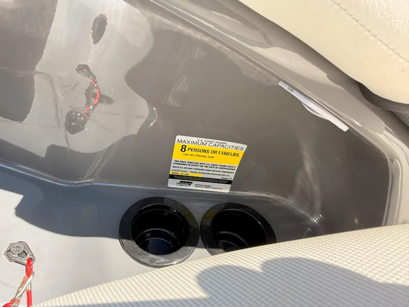 Slide: The Image of 2016 Yamaha SX190 boat interior with capacity label and cup holders. - 9