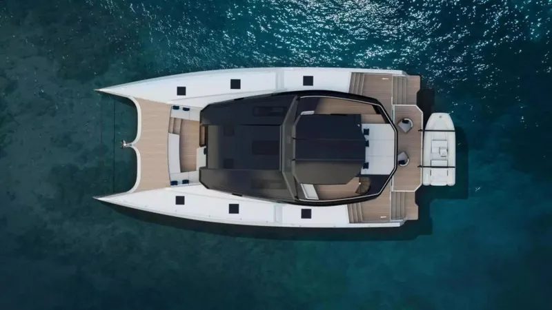 Slide: The Image of Aerial view of 2026 McConaghy MC63P Tourer catamaran on clear blue water. - 3