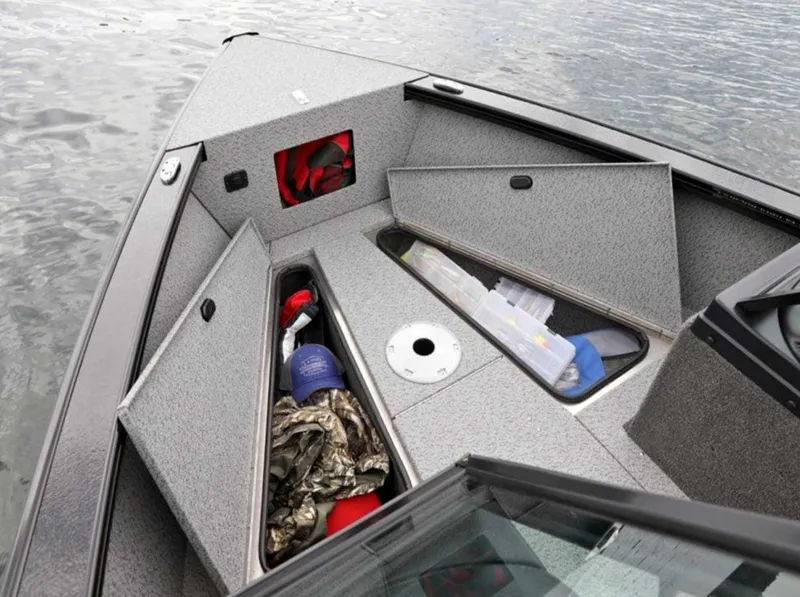 Slide: The Image of 2026 Lund 1875 Fisherman boat with open storage compartments on a calm lake. - 4