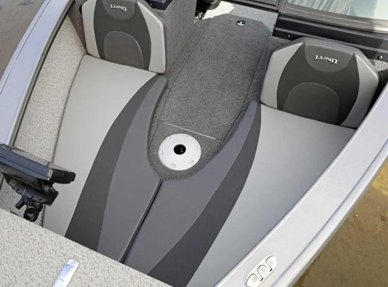 Slide: The Image of 2026 Lund 1875 Fisherman boat interior with gray seating and carpeted flooring. - 5