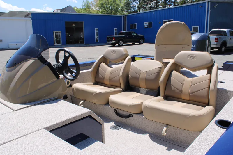 Slide: The Image of 2025 G3 Sportsman 1710 boat interior with beige seating and steering console. - 14