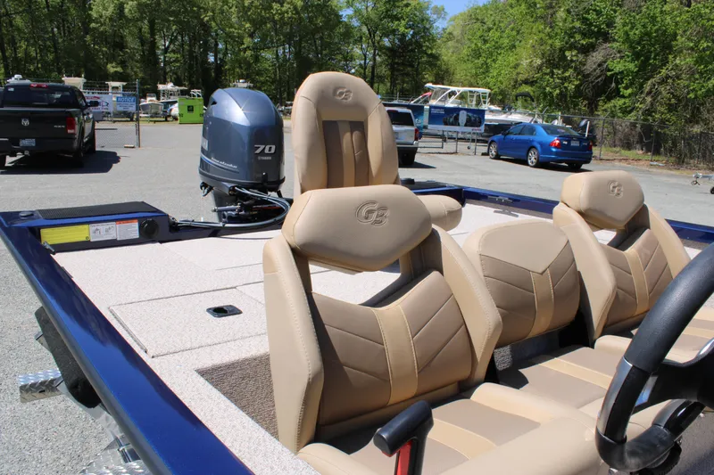 Slide: The Image of 2025 G3 Sportsman 1710 boat with beige seats and 70 HP outboard motor. - 15