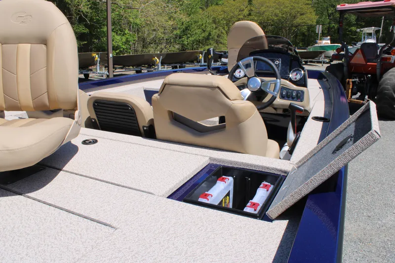 Slide: The Image of 2025 G3 Sportsman 1710 boat interior with beige seats and open storage compartment. - 16
