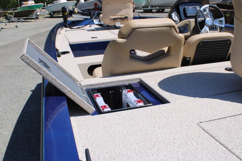 Slide: The Image of 2025 G3 Sportsman 1710 boat interior with open storage compartment and beige seating. - 17