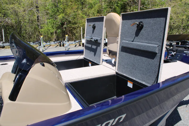 Slide: The Image of 2025 G3 Sportsman 1710 boat with open storage compartments and seating, set outdoors. - 18