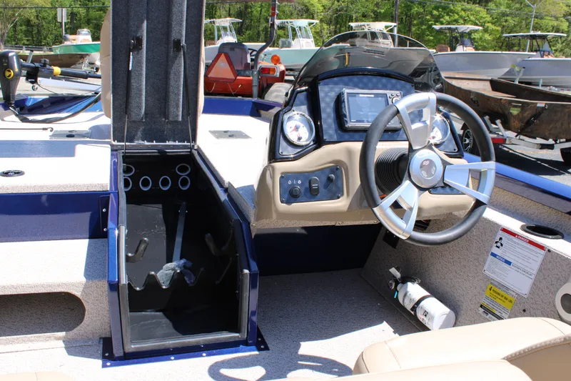 Slide: The Image of 2025 G3 Sportsman 1710 boat interior with steering wheel and storage compartment. - 22