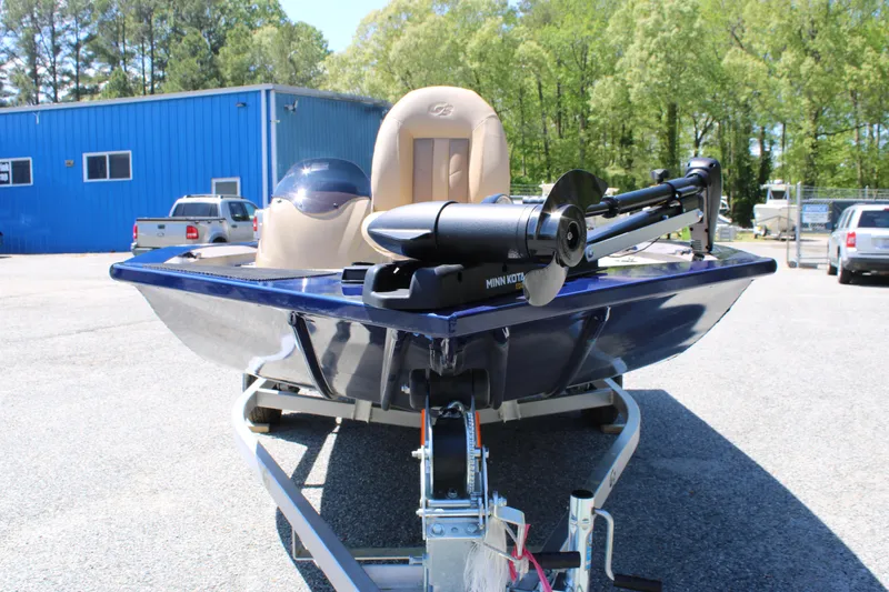 Slide: The Image of 2025 G3 Sportsman 1710 boat on trailer, featuring a trolling motor, parked outdoors. - 7