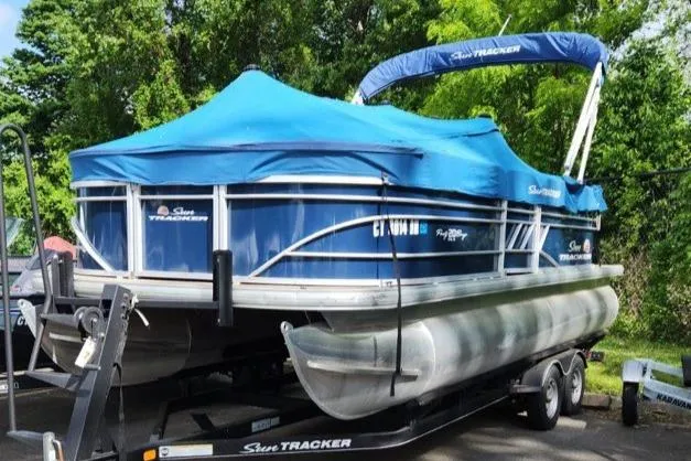 Slide: The Image of 2020 Sun Tracker Party Barge 20 DLX pontoon boat with blue cover on trailer. - 4