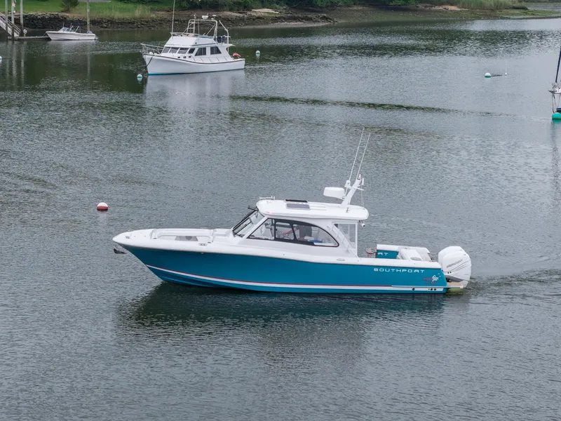 Slide: The Image of 2021 Southport 33 DC boat cruising on calm water. - 11