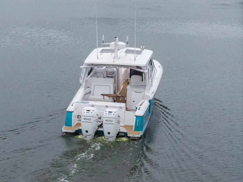 Slide: The Image of 2021 Southport 33 DC boat with dual engines cruising on calm water. - 12