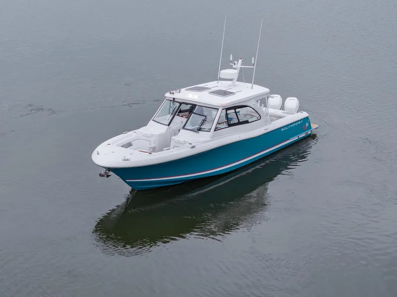Slide: The Image of 2021 Southport 33 DC boat on calm water, showcasing sleek design and modern features. - 15