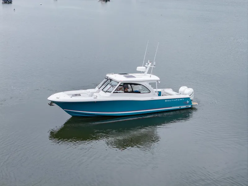 Slide: The Image of 2021 Southport 33 DC boat on calm water, showcasing sleek design and modern features. - 16