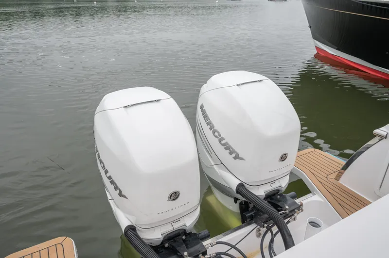 Slide: The Image of 2021 Southport 33 DC boat with twin Mercury outboard engines on calm water. - 25