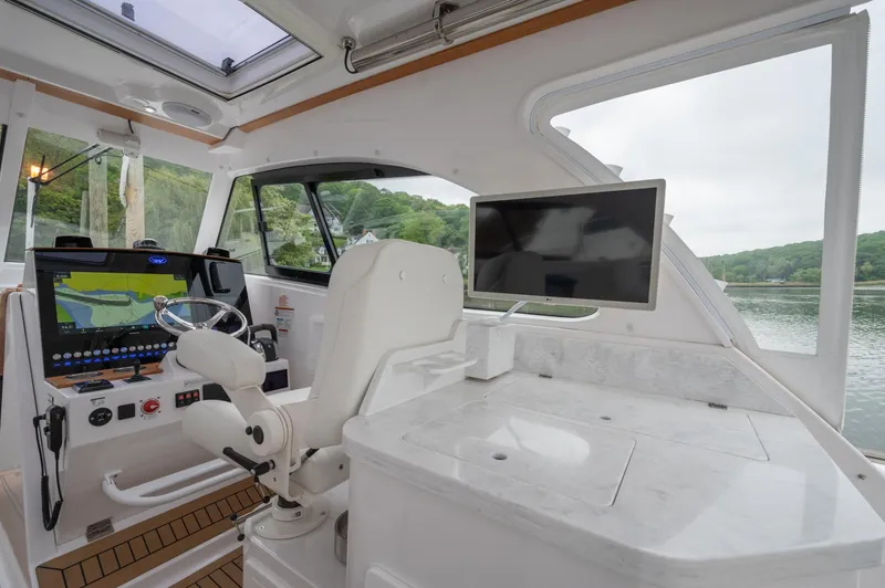 Slide: The Image of Interior of 2021 Southport 33 DC boat with modern helm and navigation screens. - 26