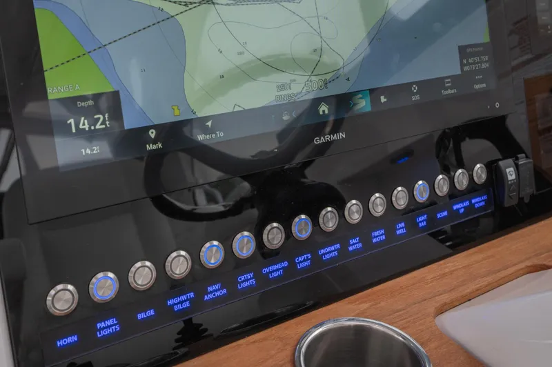 Slide: The Image of 2021 Southport 33 DC boat dashboard with Garmin navigation system and control buttons. - 29