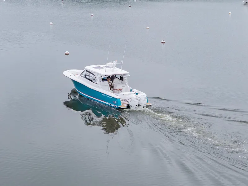 Slide: The Image of 2021 Southport 33 DC boat cruising on calm water with visible wake. - 3