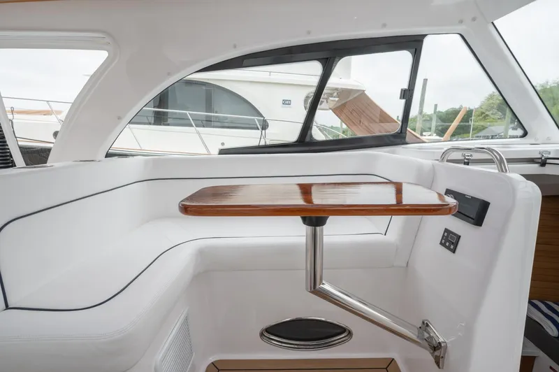 Slide: The Image of 2021 Southport 33 DC interior with sleek seating and wooden table. - 31