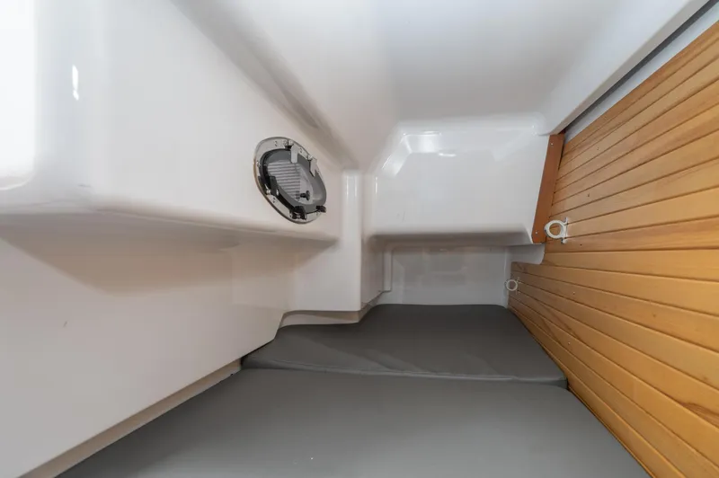 Slide: The Image of Interior cabin of 2021 Southport 33 DC boat with wooden paneling and seating. - 36