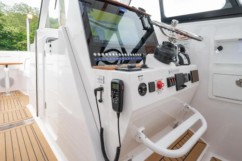 Slide: The Image of 2021 Southport 33 DC boat helm with modern controls and navigation system. - 37