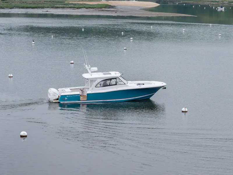 Slide: The Image of 2021 Southport 33 DC boat cruising on calm water with buoys. - 4