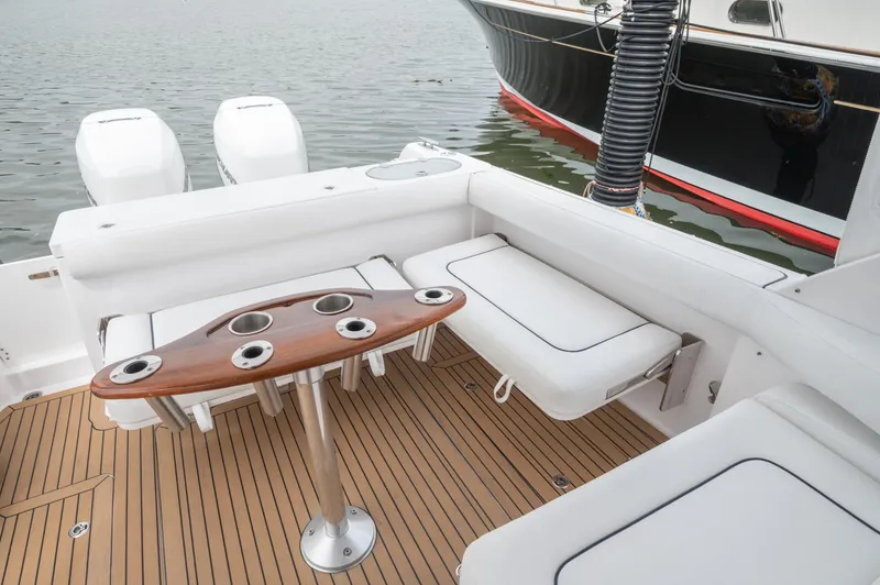 Slide: The Image of 2021 Southport 33 DC boat interior with seating and wooden table on deck. - 41