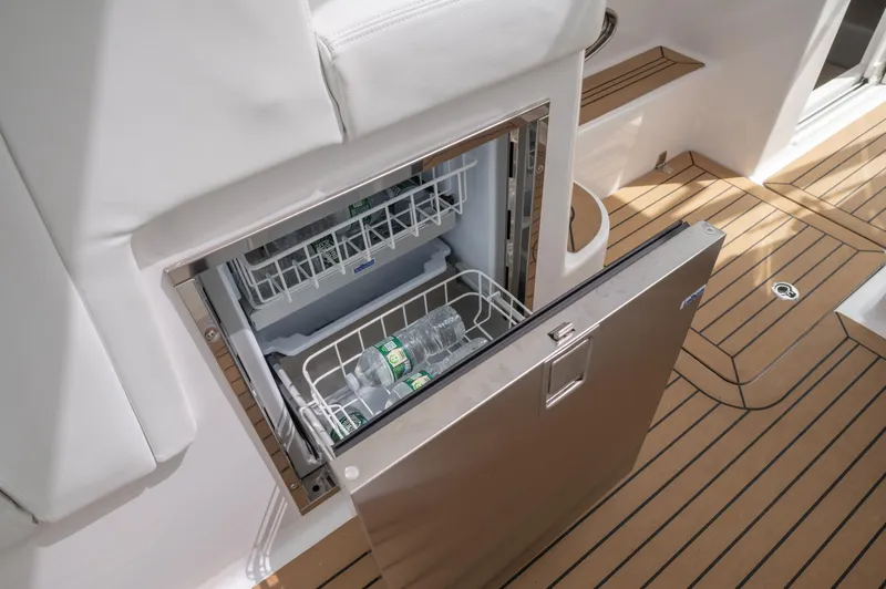 Slide: The Image of Stainless steel fridge on 2021 Southport 33 DC boat with wooden deck. - 44