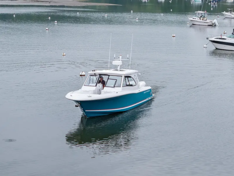 Slide: The Image of 2021 Southport 33 DC boat cruising on calm water. - 5