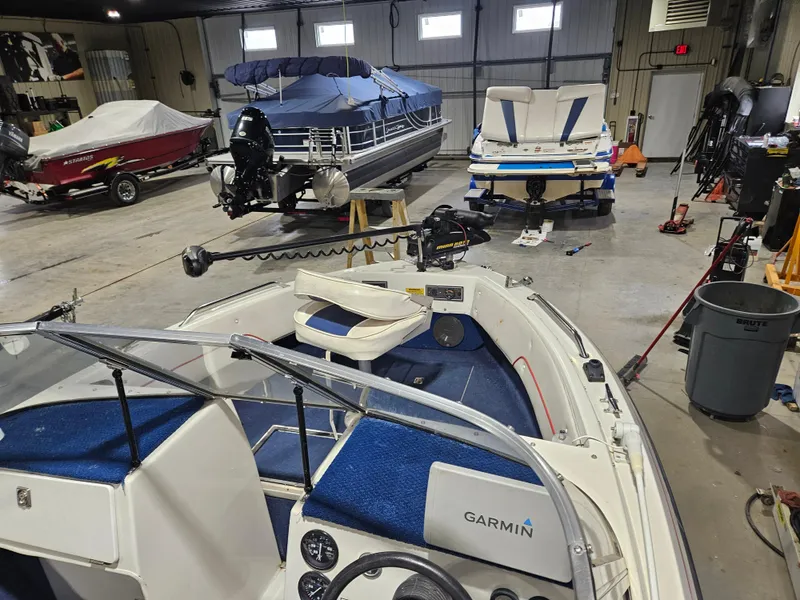 Slide: The Image of 1997 Yar-Craft 192 Michigan boat in a garage with other boats and equipment. - 5